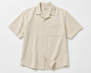 Front vew of men's loose fit short sleeve summer shirt in beige with button-up closure.