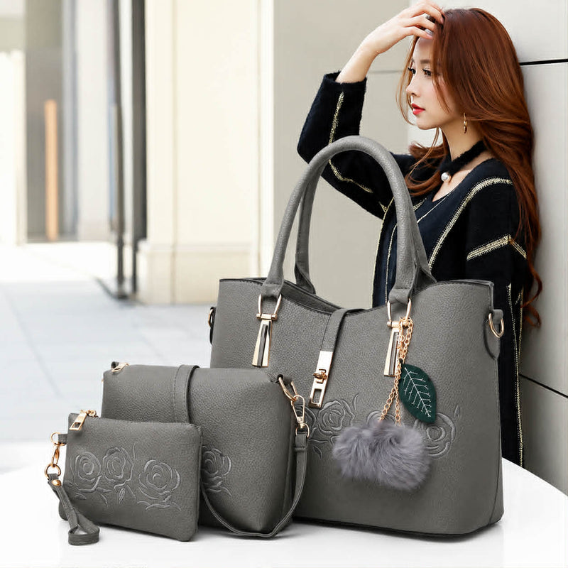 Gray 3-piece women’s embossed rose handbag set with shoulder bag and wallet displayed in a stylish lifestyle setting