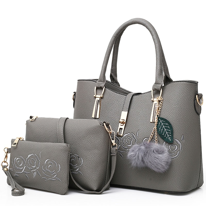 Gray 3-piece women’s handbag set with embossed rose pattern and matching accessories
