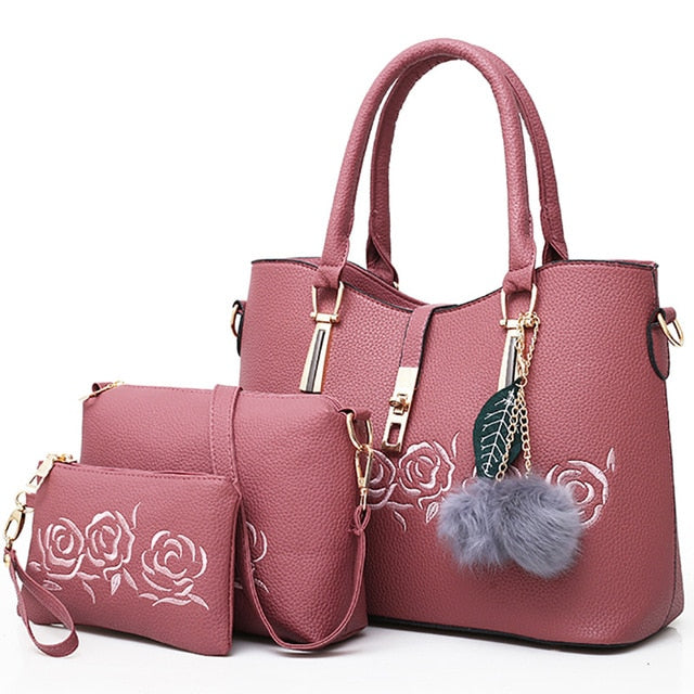Pink 3-piece women’s handbag set with tote bag, shoulder bag, and wallet featuring embossed rose design