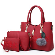 Red 3-piece women’s handbag set with embossed floral rose design and matching wallet