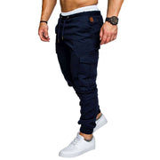 slim fir cargo joggers for men in navy worn by a model with white sneakers