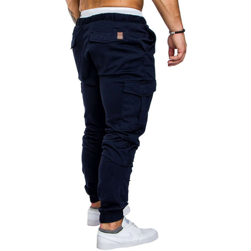 Back view of slim fir cargo joggers for men, featuring a comfortable fit and cargo pockets, styled with white sneakers.