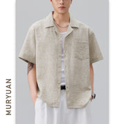 Male model wearing apricot textured Cuban collar loose fit shirt
