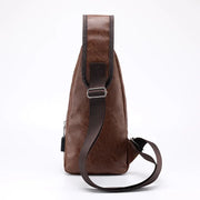 Back view profile of a men’s brown leather sling bag showing the adjustable strap and slim ergonomic shape.