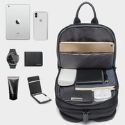 Interior layout of the BANGE Anti-Theft USB Crossbody Sling Bag showing organized compartments holding an iPad, iPhone, notebook, watch, power bank, and daily essentials.