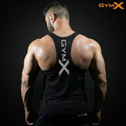Man wearing a black GymX racerback fitness tank top, highlighting defined back muscles on a dark studio background.
