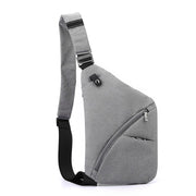 Gray tactical crossbody sling bag designed for left-shoulder carry, featuring a curved zipper pocket and adjustable strap.

