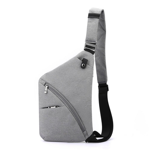 Gray tactical CCW-style sling bag optimized for right-shoulder carry, showcasing a minimalist design and angled zipper pocket.
