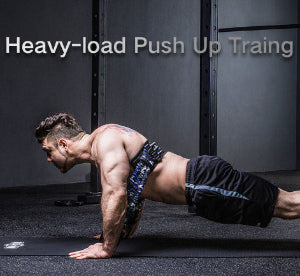 Man performing heavy-load push-up training on gym floor.