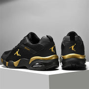 Black and gold men’s athletic shoes with breathable mesh upper and sporty design
