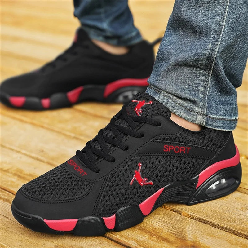 On-foot view of men wearing black red mesh athletic sneakers for casual sports use