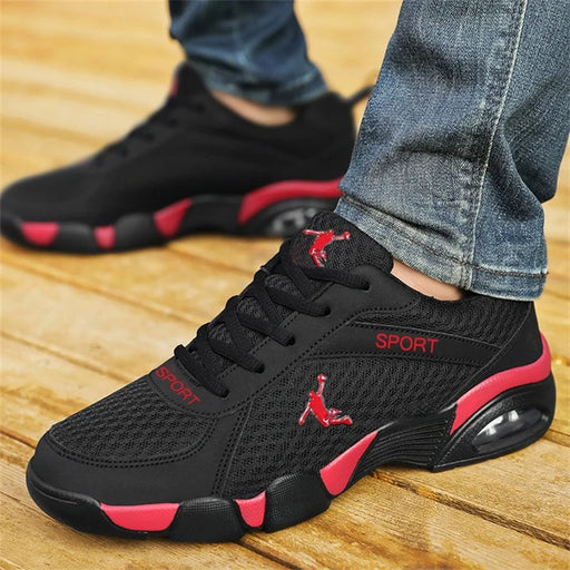 On-foot view of men wearing black red mesh athletic sneakers for casual sports use
