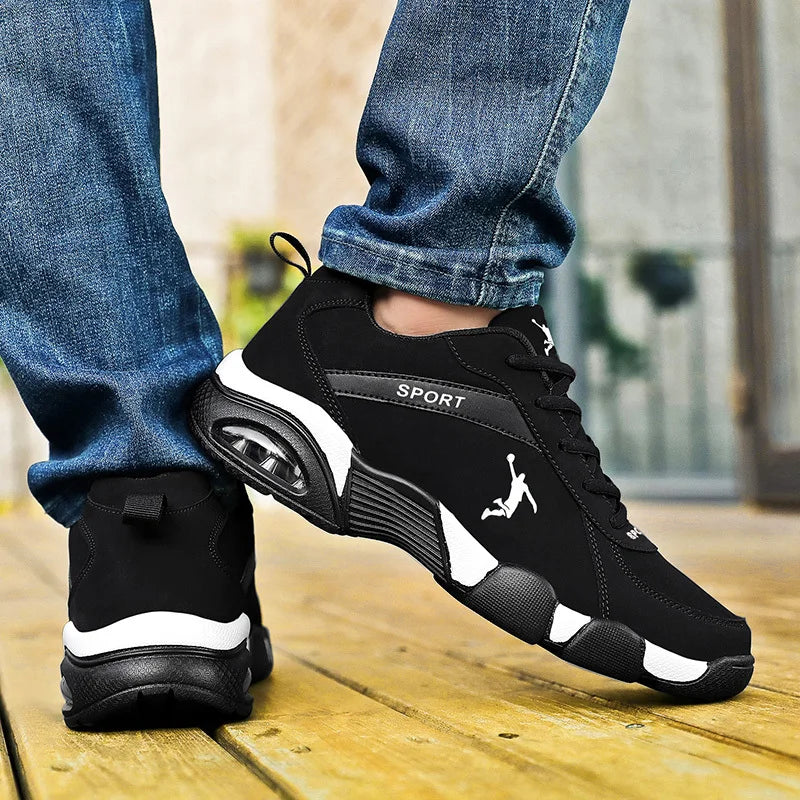 Black and white men’s leather athletic sneakers with lightweight cushioned sole on foot.