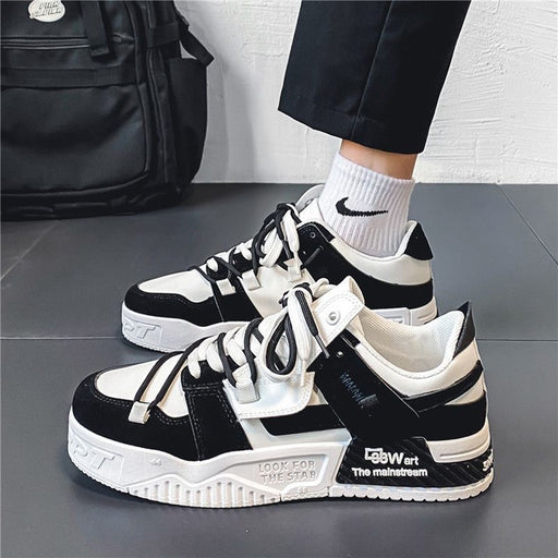 Men's black and white non slip outdoor sneakers worn for walking and casual sports use.