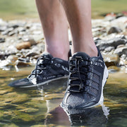 Men’s quick-dry water sport shoes worn while walking in shallow river, non-slip outdoor wading footwear
