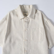 Close-up of men’s beige short sleeve summer shirt with front pocket and button-up style