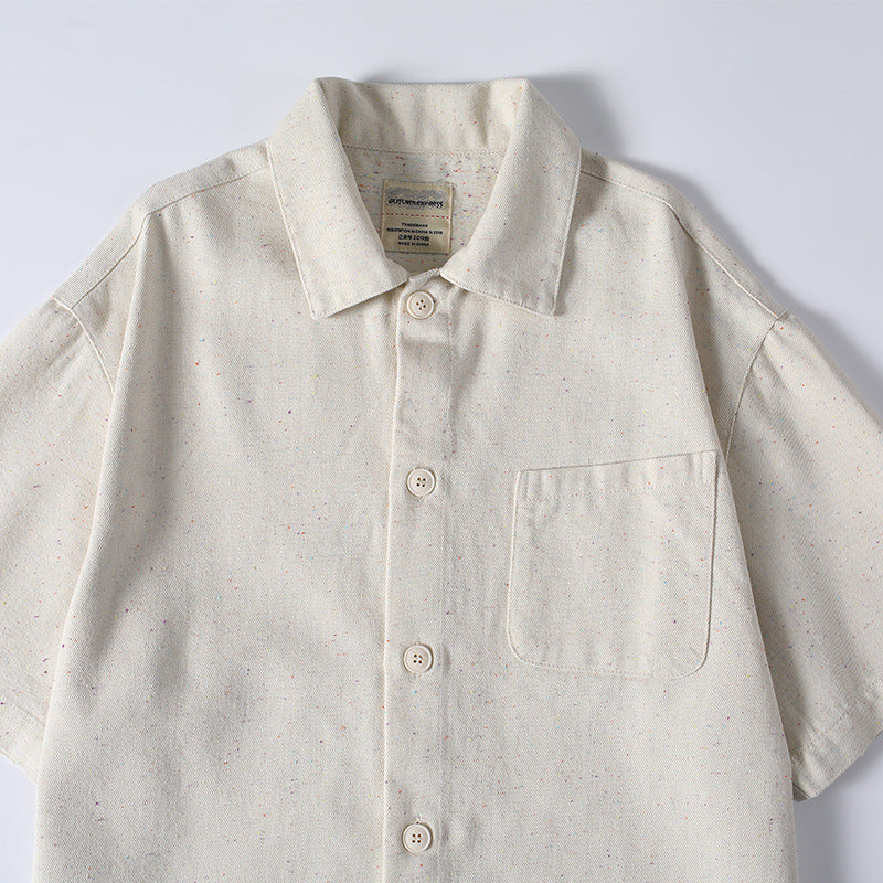 Close-up of men’s beige short sleeve summer shirt with front pocket and button-up style