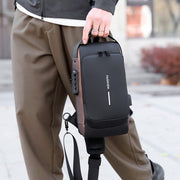 Man carrying a men’s waterproof anti-theft crossbody sling bag with USB charging port, front angle.