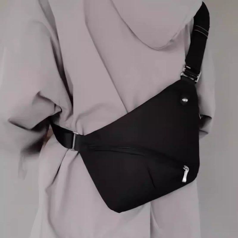 Back view of a person wearing a black tactical CCW sling bag with adjustable strap and slim profile.
