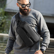 Male model wearing the BANGE Anti-Theft USB Crossbody Sling Bag across the chest, showcasing its sleek and modern design for everyday use.