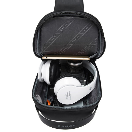 Interior of the BANGE Waterproof Tech Sling Bag displaying organized storage space holding headphones, phone, and daily essentials.