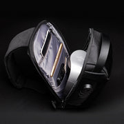 Interior view of sling bag showing multiple compartments for phone, wallet, and essentials.