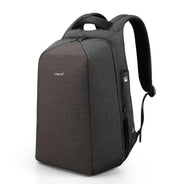 Side angle view of the grey anti-theft laptop backpack, featuring ergonomic shoulder straps and hidden side zipper pocket.