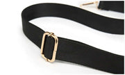 Close-up of the adjustable shoulder strap with gold-tone hardware on a puffer tote bag.
