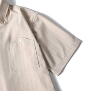 Short sleeve view detail of beige retro loose fit short sleeve button-up shirt with  chest pocket.

