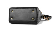 Bottom view of black crocodile texture handbag with protective metal feet for durability
