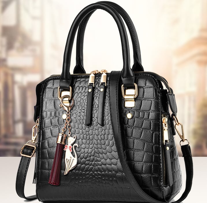 Black crocodile pattern handbag with gold accents and detachable shoulder strap
