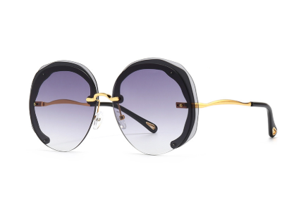 Black double grey rimless oversized cut lens sunglasses with gradient lenses and gold metal temples for women.
