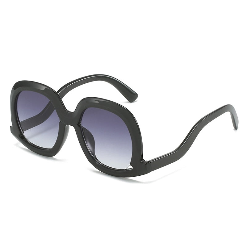 Oversized black oval sunglasses with gray gradient lenses featuring a lightweight fashion frame and UV400 protection.
