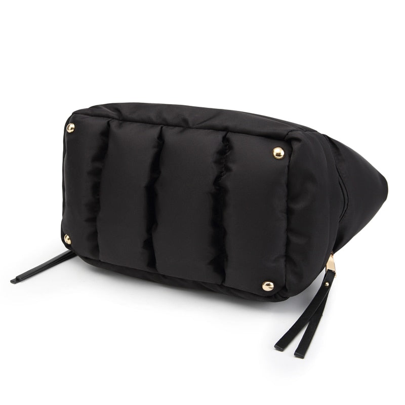 Bottom view of a black padded tote bag showing reinforced base and durable construction.
