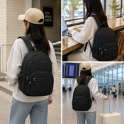 Black quilted backpack shown in urban, workspace, and airport settings, designed for travel, work, school, and everyday use.
