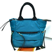 Blue winter puffer tote bag featuring lightweight quilted construction and spacious storage.
