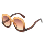 Champagne brown oversized oval sunglasses with tea gradient lenses offering elegant vintage-inspired fashion styling.
