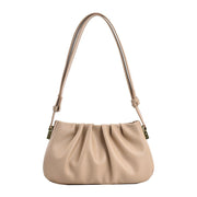 Apricot cloud soft shoulder bag featuring a smooth pleated texture, adjustable strap, and versatile everyday fashion appeal.
