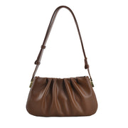 Auburn brown cloud soft shoulder bag featuring a soft pleated silhouette, adjustable strap, and minimalist modern design.
