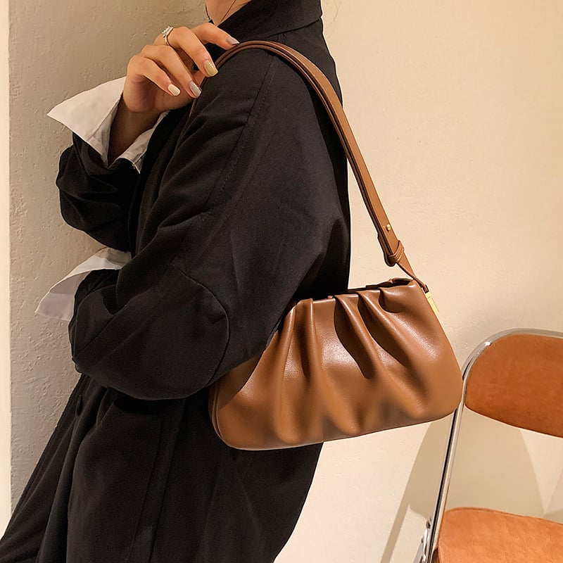 Auburn cloud soft shoulder bag worn with a black blazer, showcasing a chic minimalist shoulder bag style.
