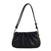 Black cloud soft shoulder bag with pleated design, adjustable shoulder strap, and gold-tone hardware for everyday elegance.
