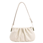 White cloud soft shoulder bag with a soft gathered design, adjustable shoulder strap, and chic minimalist styling.
