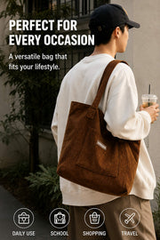 Person carrying a brown corduroy tote bag for daily use, school, shopping, and travel.
