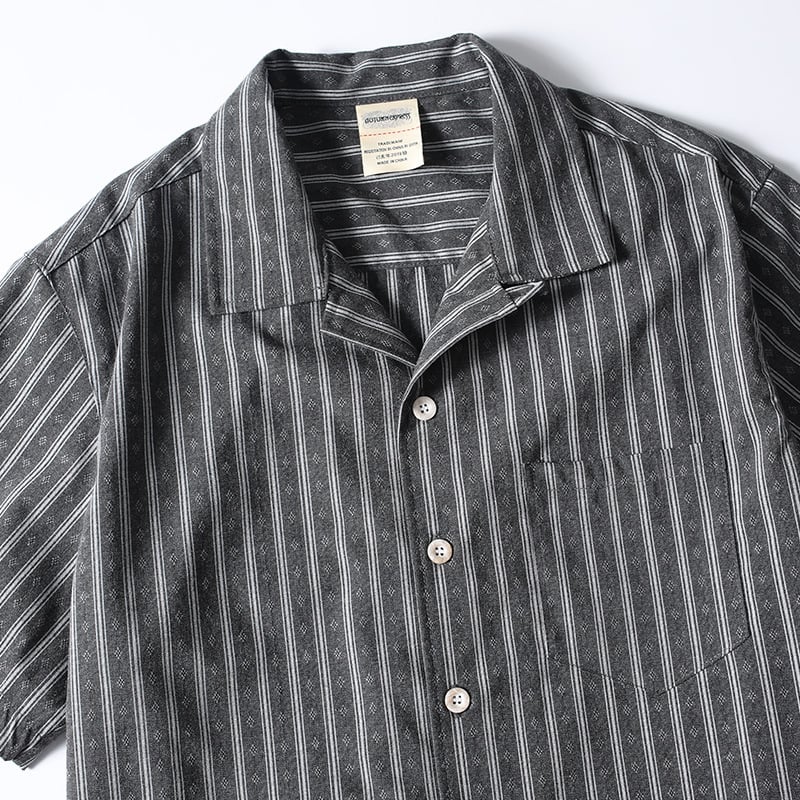Close-up detail of striped Cuban collar button-up shirt