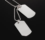 Double dog tag necklace in polished stainless steel with ball hain on dark background