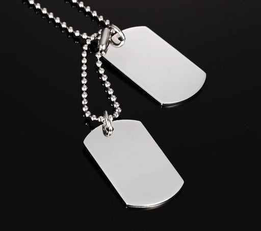 Double dog tag necklace in polished stainless steel with ball hain on dark background
