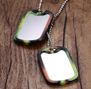 Double dog tag necklace with stainless steel pendant and colored edge reflection on wooden background