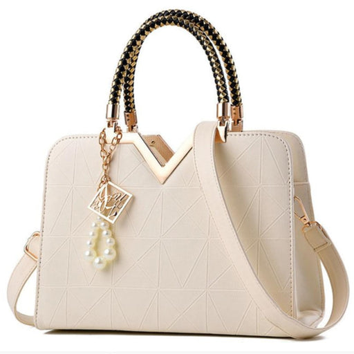 Elegant women's handbag in cream white color with gold accent top handle
