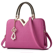Elegant rose red women's handbag with gold accent handle and shoulder strap
